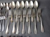 a lot of silver spoons and forks on a table