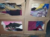 four cardboard boxes with different types of clothes in them