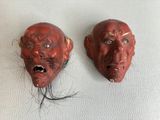 une paire de masques rouges avec des cheveux sur un fond blanc