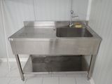 a stainless steel sink in a bathroom with a faucet