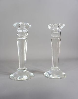 deux bougeoirs en verre transparent posés sur une table