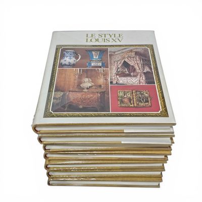 several books stacked on top of each other on a white surface