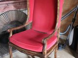 a red chair with a red cushion in a room