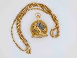 an image of a gold pocket watch with a chain on a white surface