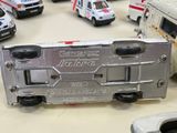 many toy ambulances and trucks on a table