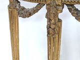 a marble top table with gold legs and a black marble top