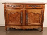 an old wooden cabinet with a marble top and two doors