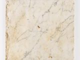 a white marble slab with a brown vein on it