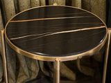 a black and gold table with a marble top