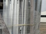 a large pile of windows sitting on a pallet