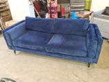 a blue couch that is sitting in a room