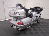a silver motorcycle that is parked on a black and white checkered floor