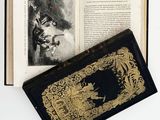 a black book with a gold cover and a picture of a man on a horse