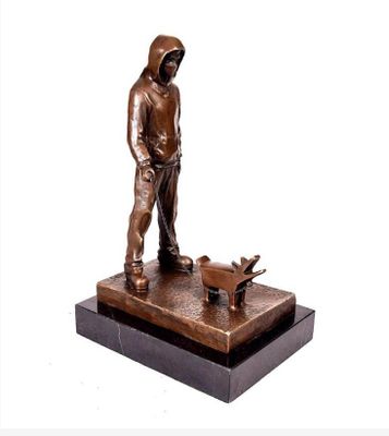statue en bronze représentant un homme avec un chien, posée sur un socle en marbre