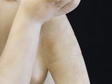 a statue of a woman holding her hands to her face