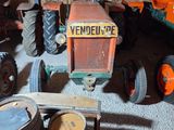many old tractors and other farm equipment in this garage