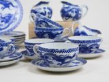 several blue and white dishes and cups and saucers on a table