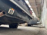 two cars parked in a garage with a number plate on the back