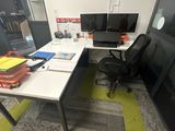 a desk with a chair and a computer on it