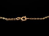 a gold bracelet with a snake on a black background