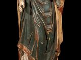 an old statue of a woman holding a bird on a black background