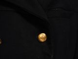 a close up of a black coat with gold buttons