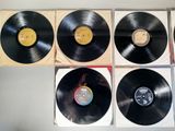 four black vinyl records sitting on top of each other on a table