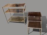 two metal and glass side tables on a gray surface