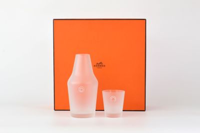 an orange box with two glasses and a bottle on a table
