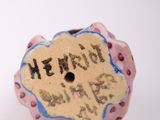 a small ceramic object that has writing on it