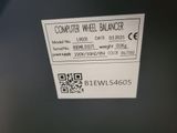 a label on the back of a computer wheel balancer