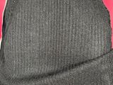 the hat is made of wool and has a brown leather band