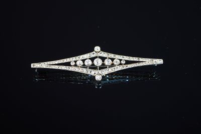 a diamond and white gold broochle