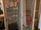 a picture of a refrigerator in a room with a lot of clutter on the floor