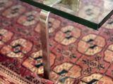 a coffee table with a glass top on a rug