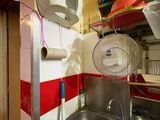 a kitchen with a sink and a toilet in it