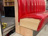 a red couch sitting in the back of a moving truck