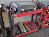 a red work cart with tools on it in a garage