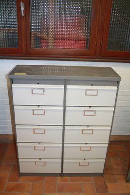 a white chest of drawers in front of a window