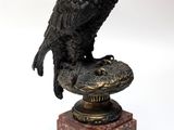 a statue of a bird sitting on top of a pedestal