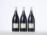 three bottles of wine sitting on top of a table next to each other