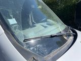 a white van with a windshield that has a windshield wiper on it