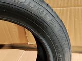 tire tread of a motorcycle on a wooden floor with a cardboard box in the background
