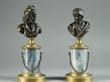 pair of bronze busts of a man and a woman on marble bases