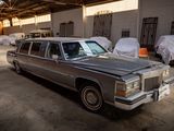 a silver car parked in a garage next to other cars