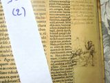 a piece of paper taped to a book with numbers on it