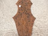 an old rusted metal arrow on a white carpet