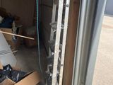 a pile of boxes and a ladder in a garage