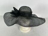 a close up of a black hat with a flower on it