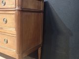 an image of a wooden dresser with marble top